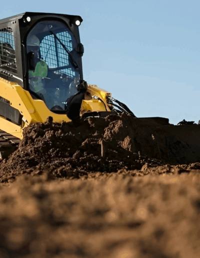 skid steer using for grading land